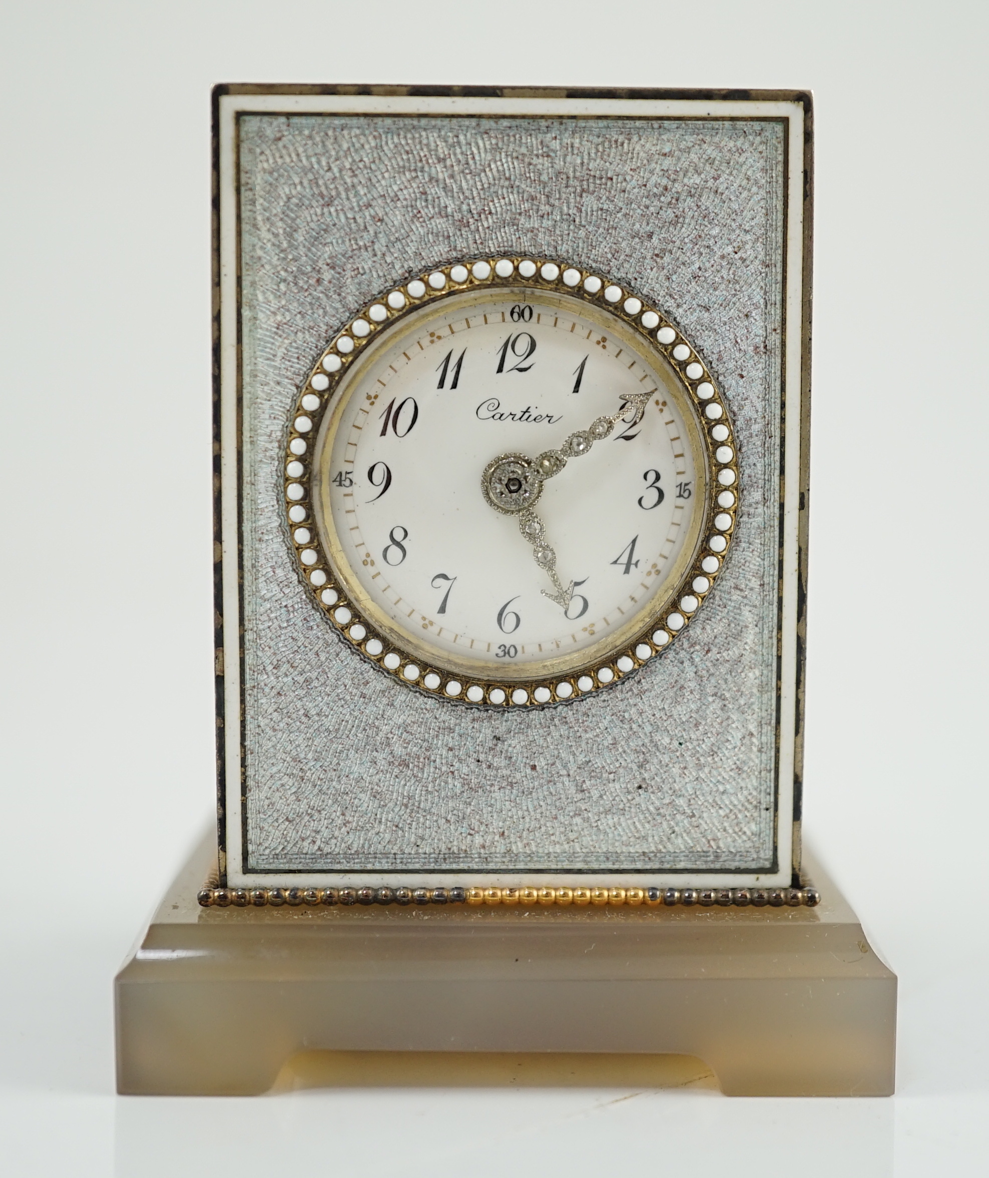 A fine Belle Époque Cartier silver, gold, diamond and guilloche enamel mounted 'Mignonette' timepiece, on an agate plinth base